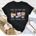 Black cotton loose fit t-shirt with round neck and short sleeves on a hanger.
