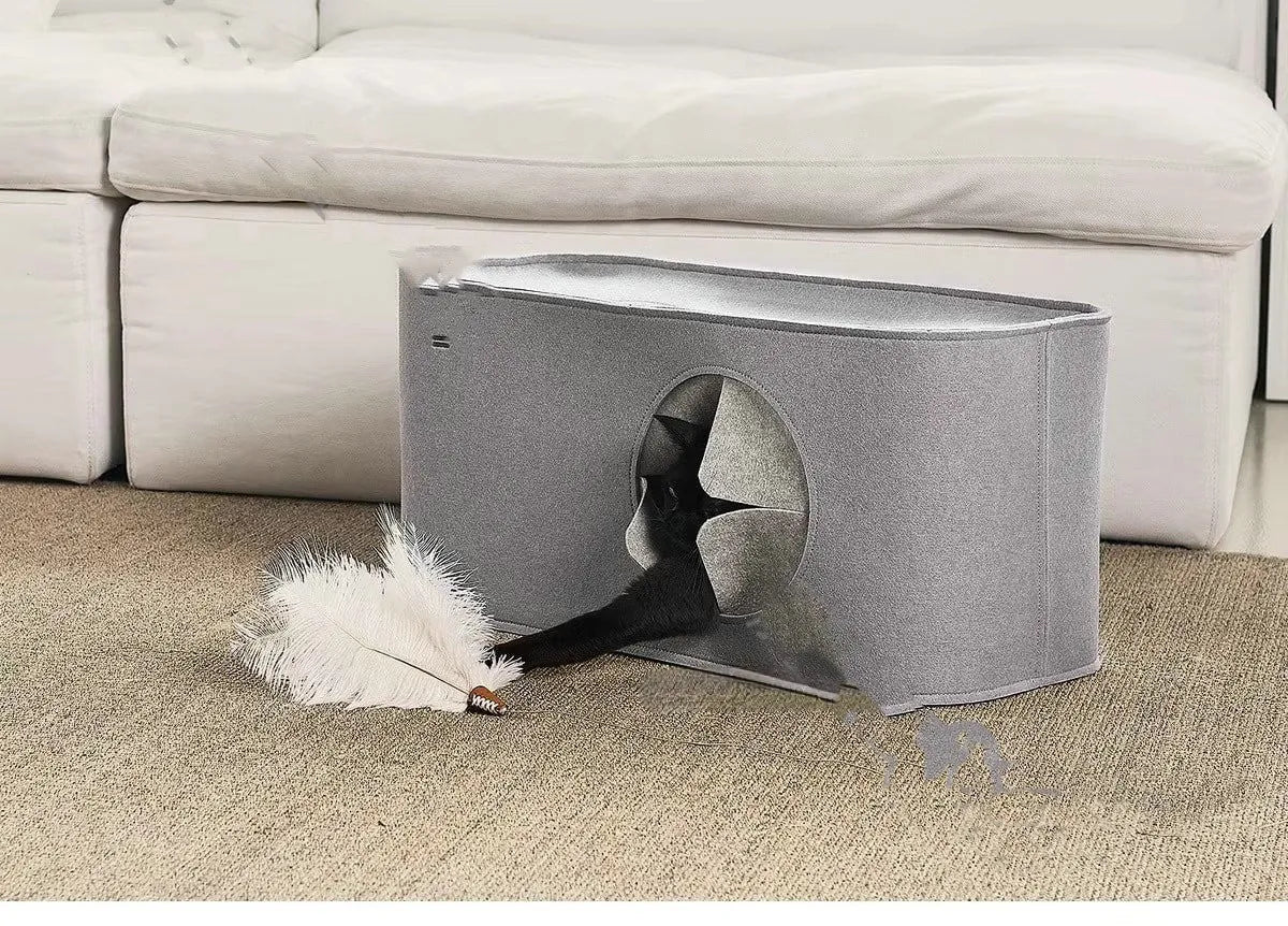 Grey foldable felt cat nest bed showing its size next to a cat.
