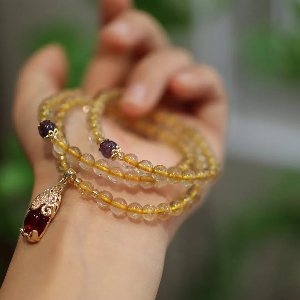 Natural Brazil gold rutilated quartz bracelet with Chinese style design featuring hanging chopsticks and three circles pattern