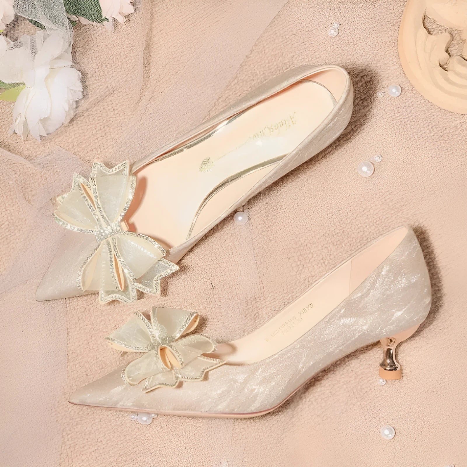 Women's champagne gold sequinned pointed-toe pumps with a stiletto heel on a rubber sole.