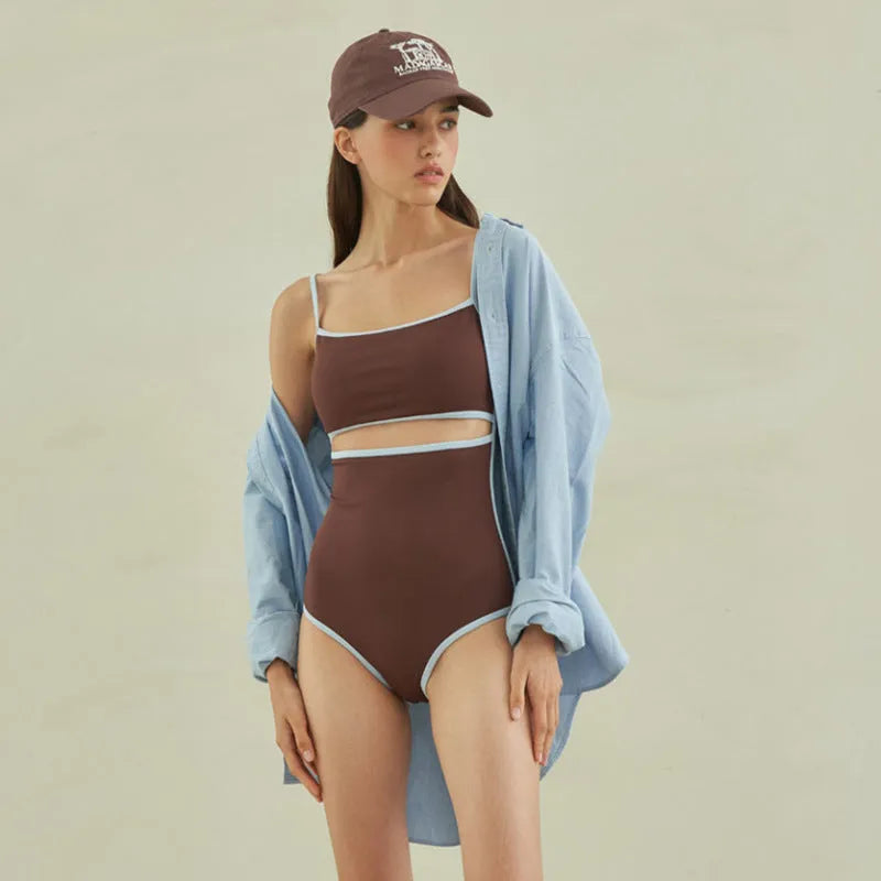 Brown women's one-piece triangle top swimsuit on hanger