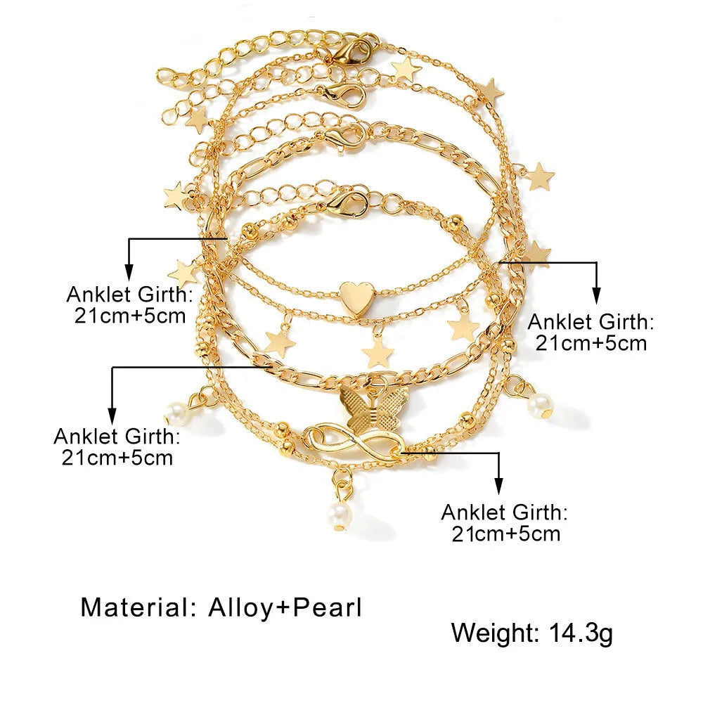 Four gold-tone alloy anklets with butterfly and heart pearl charms arranged as a set