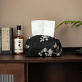 White Chinese brocade fabric tissue box with embroidered plum blossoms, shown with and without a pearl buckle clasp.