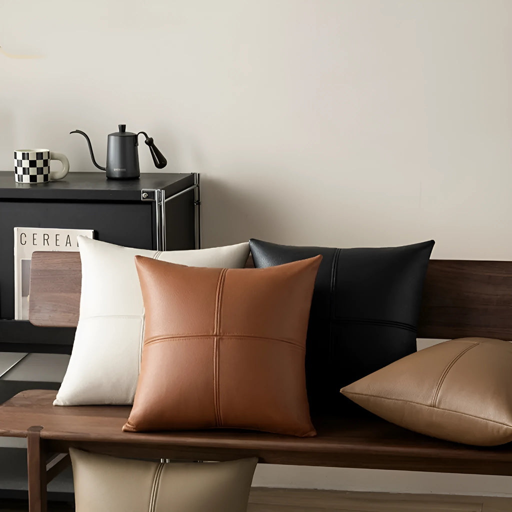 Simple solid colour soft cowhide leather pillow cover on a sofa in a nordic style room.
