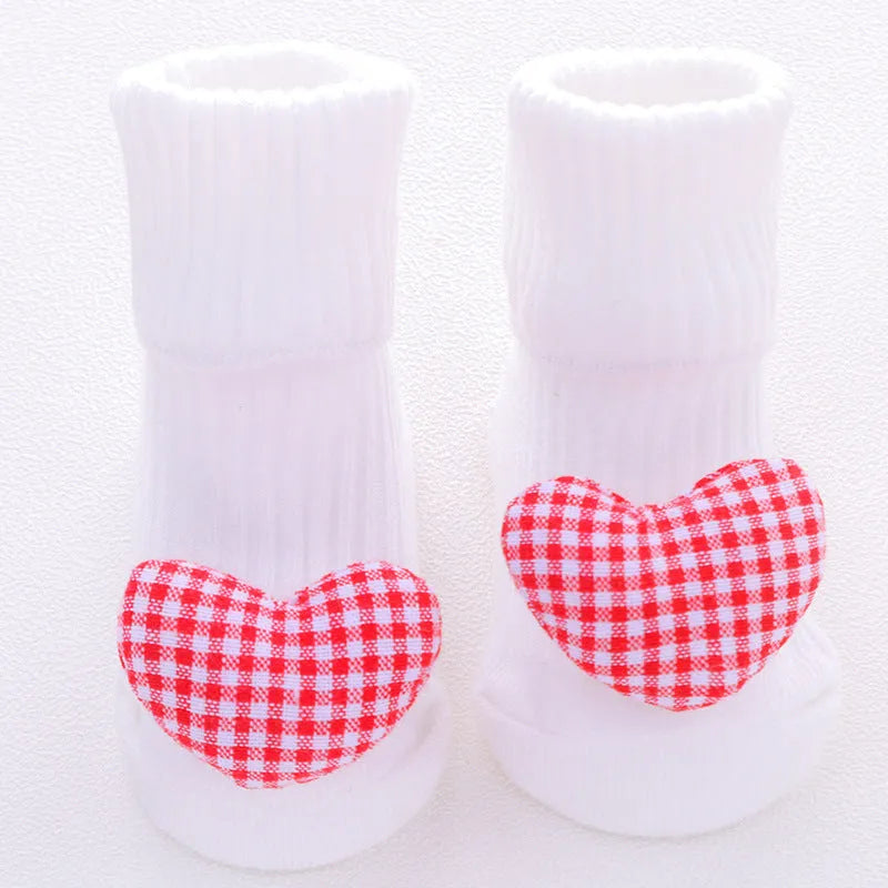 Cotton baby socks in multiple colours and prints including panda, lion, bows, and stars on a white background.
