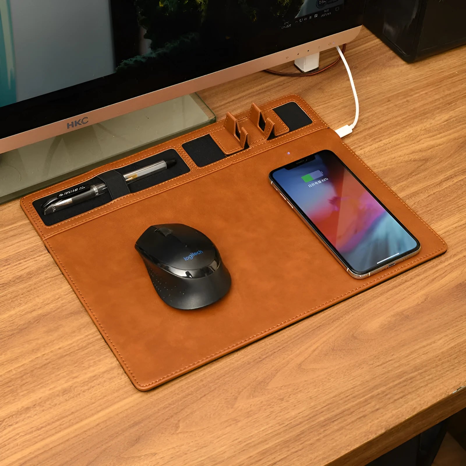 Pink wireless charging mouse pad with phone holder on a desk, showing USB cable and 320x260mm size.