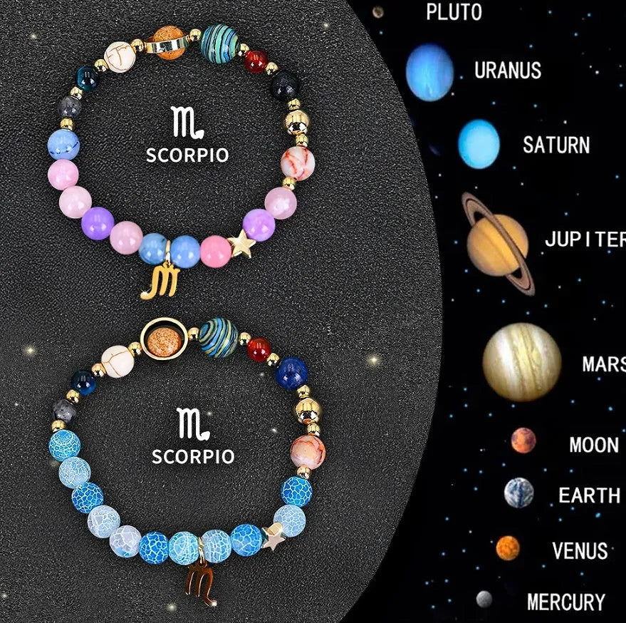 Two natural stone beaded bracelets showing zodiac sign designs on a wooden surface.