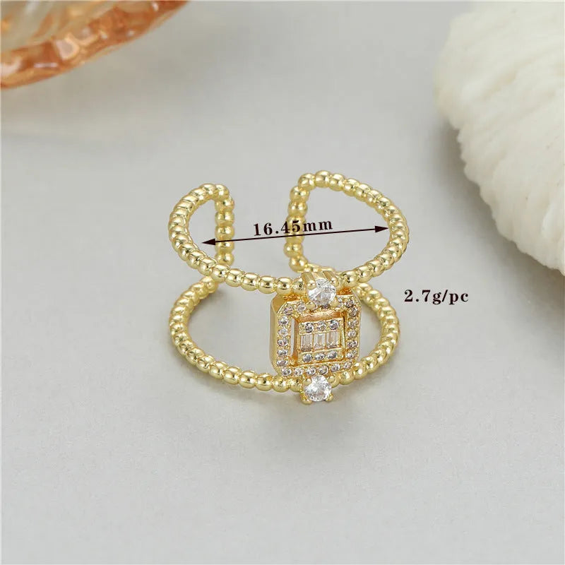 Gold-plated copper open ring with an asymmetric U-shape and adjustable opening.