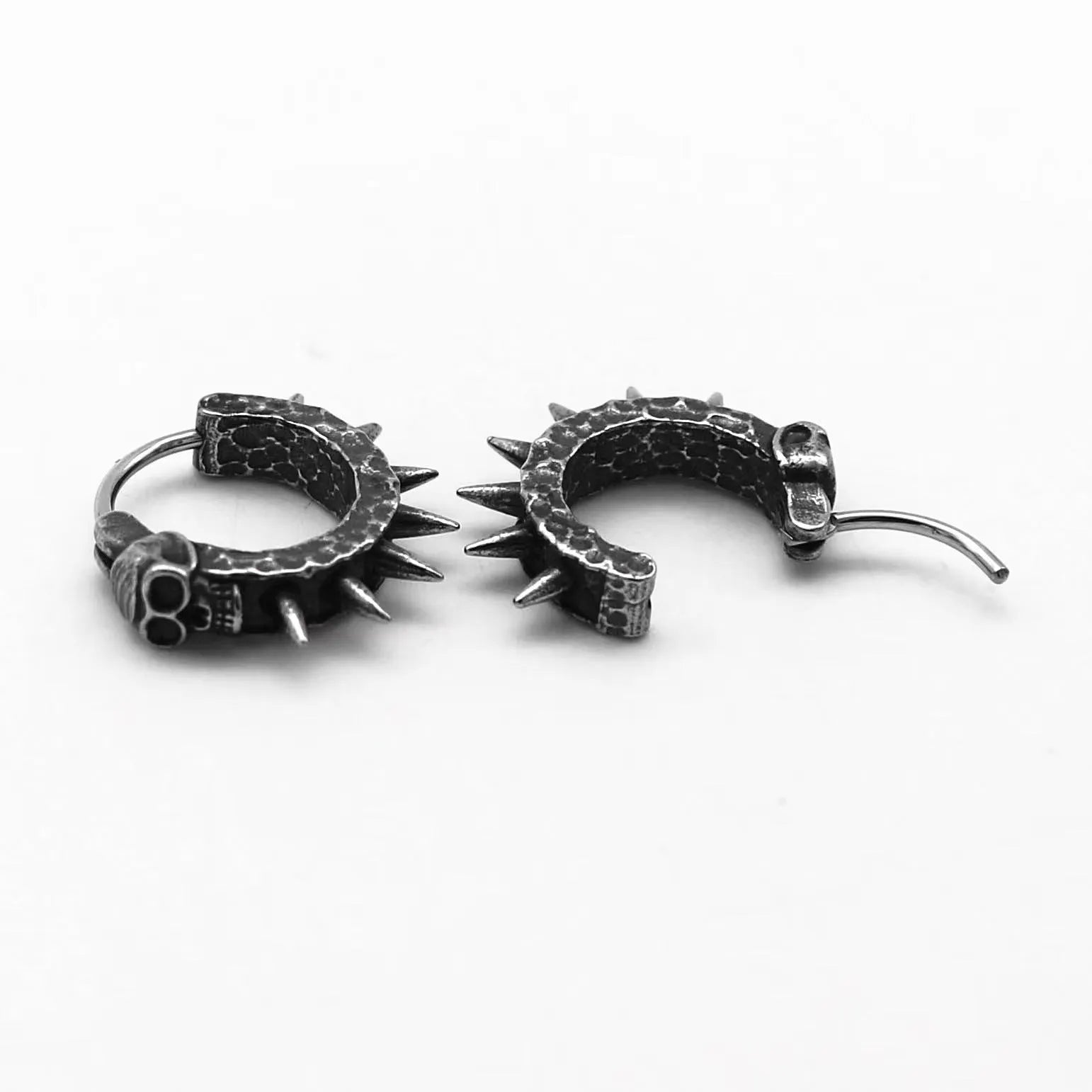 A pair of copper-coloured geometric punk motorcycle earrings with a black retro design on a hook fastening.