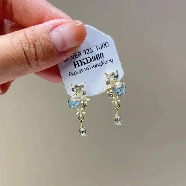 Alloy heart-shaped geometric ear clip with rhinestone detailing and star tassels