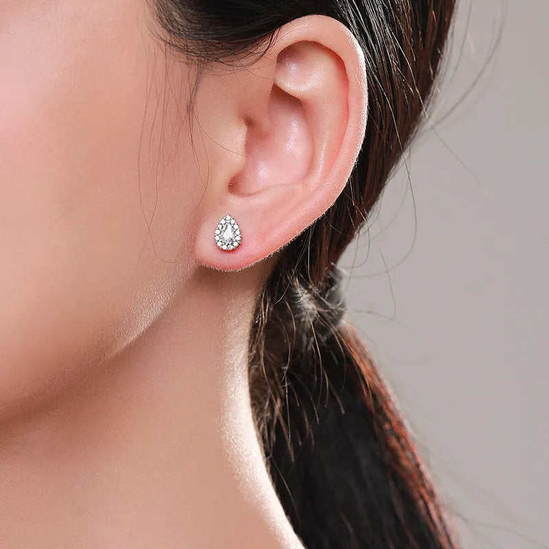 A pair of women's silver water drop shaped stud earrings made from 925 sterling silver.