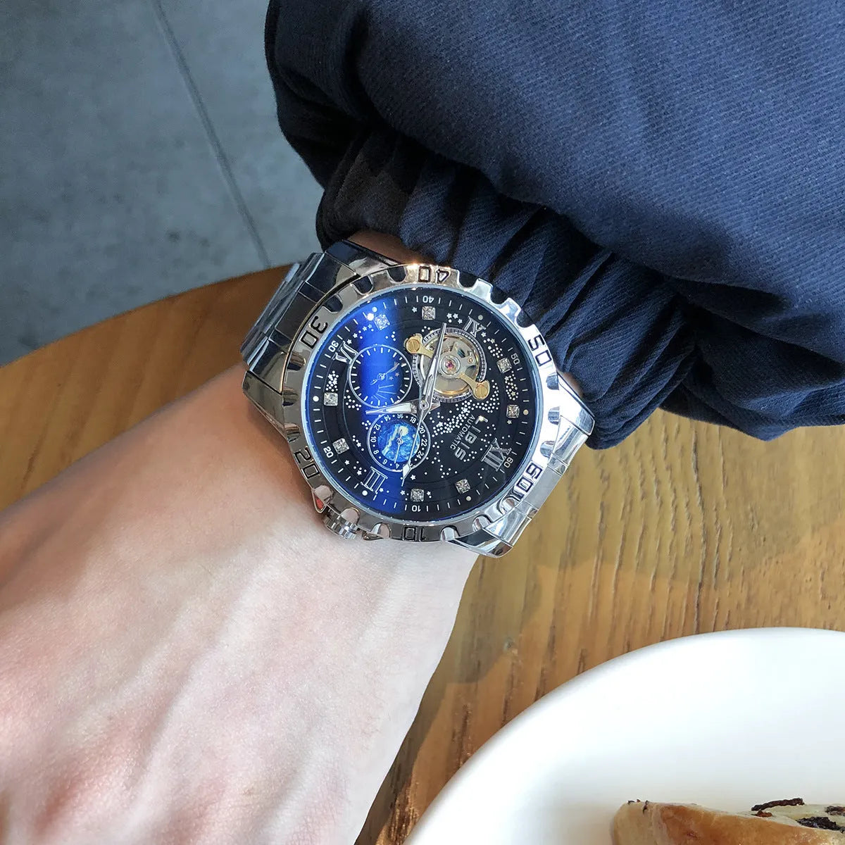 Men's silver case automatic mechanical watch with black starry dial, luminous hands, and leather strap
