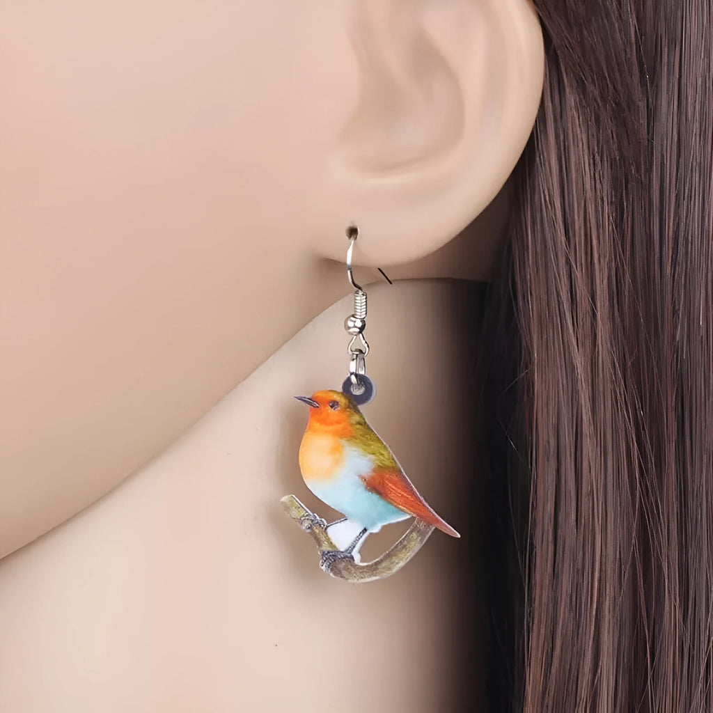 A pair of blue titmouse and snake design acrylic pendant earrings with geometric shape.