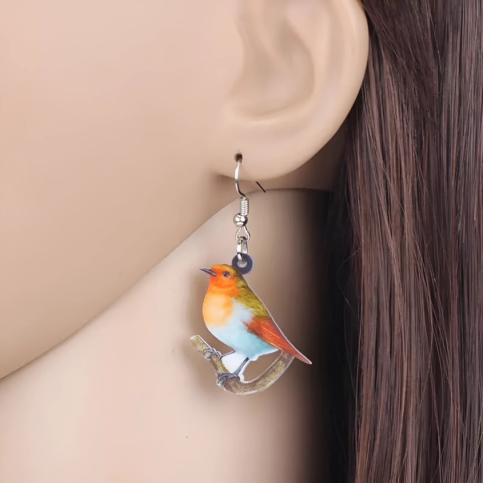 A pair of blue titmouse and snake design acrylic pendant earrings with geometric shape.
