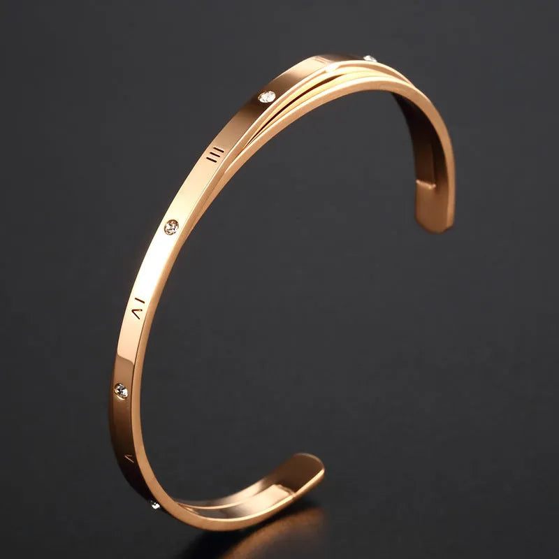 Open-ended stainless steel bracelet with zircon detailing showing rose gold, gold and steel colour options