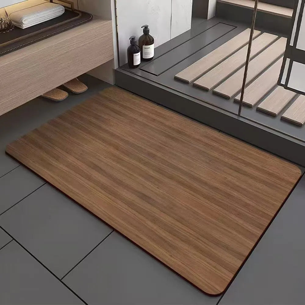 Square diatomite bathroom mat with wood grain pattern on a bathroom floor.