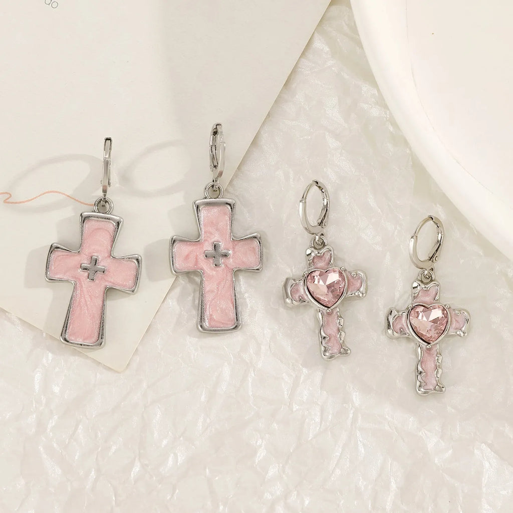 Women's classic alloy earrings showing cross, heart, and animal designs in white, black, and silver colours