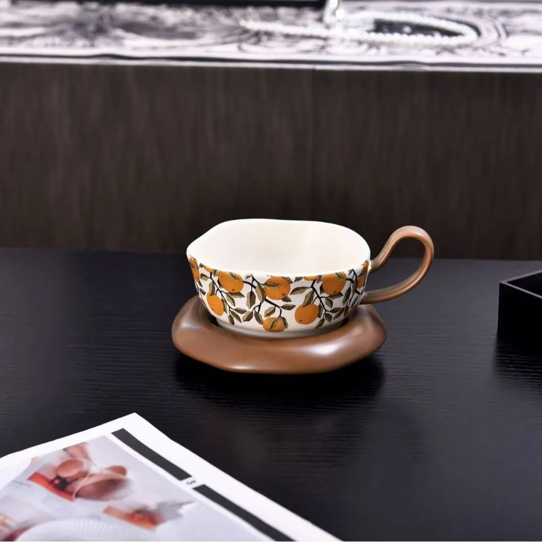Antique style ceramic coffee cup and saucer with 210ml capacity in black pomegranate or orange citrus pattern.