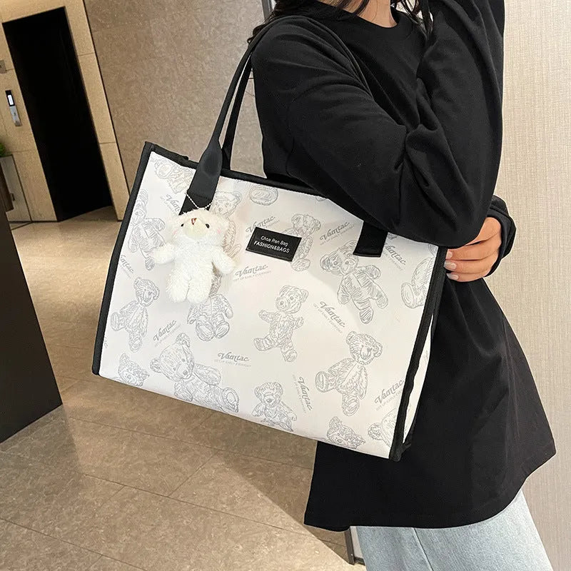 Women's black canvas tote bag with rhombus pattern showing sandwich pocket organisation interior