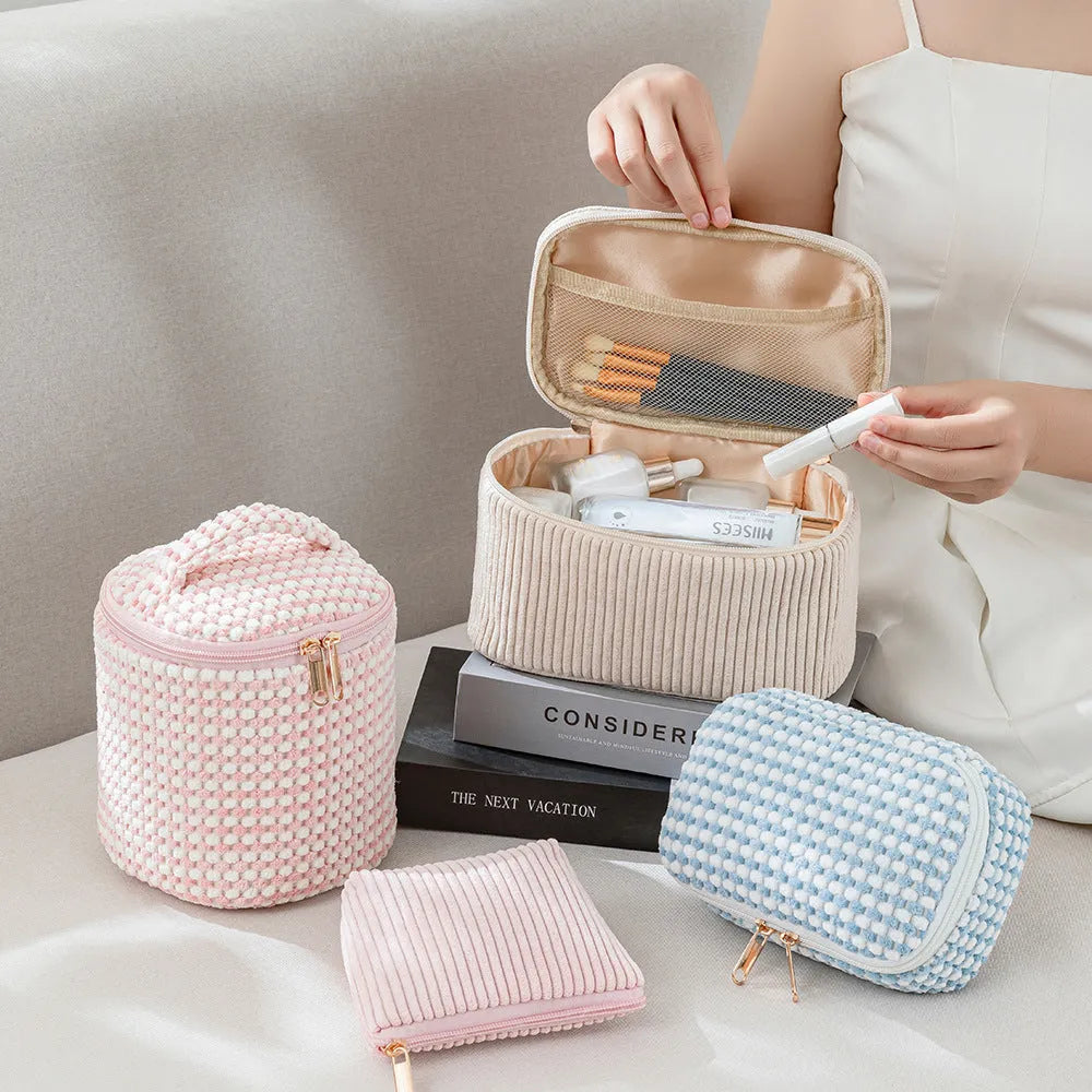 Four cube-shaped polyester makeup bags in matching colour set for travel organisation