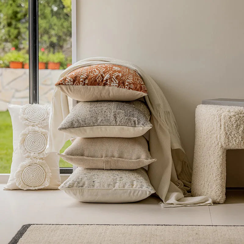 Solid colour rectangular and square sofa cushions with removable covers on a bay window seat