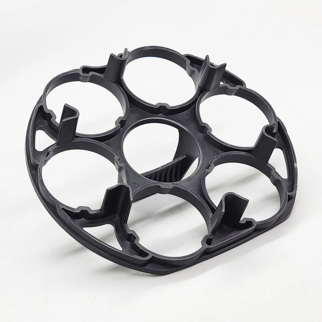 Black plastic egg holder cooking basket rack on a kitchen counter.
