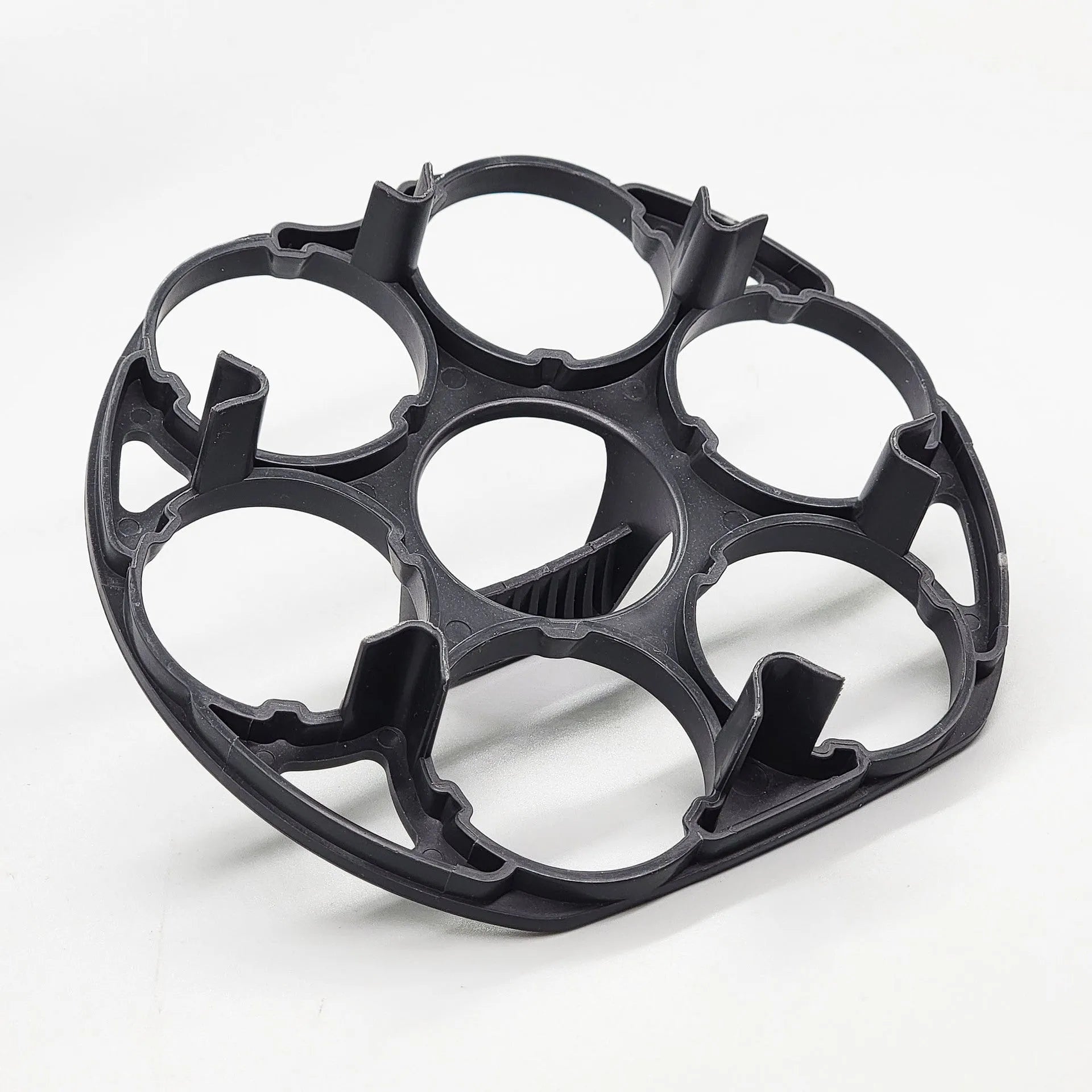 Black plastic egg holder cooking basket rack on a kitchen counter.