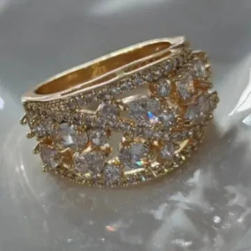 Women's hollow round copper fashion ring showing gold and platinum finishes with sapphire blue and white diamond accent options