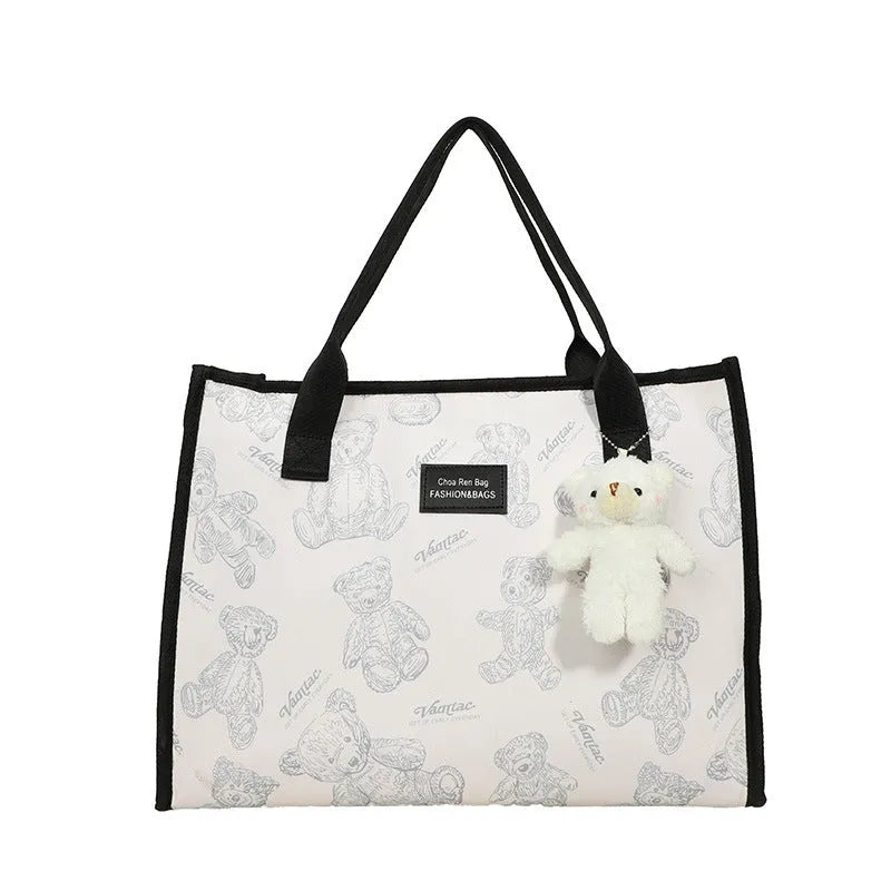 Women's black canvas tote bag with rhombus pattern showing sandwich pocket organisation interior