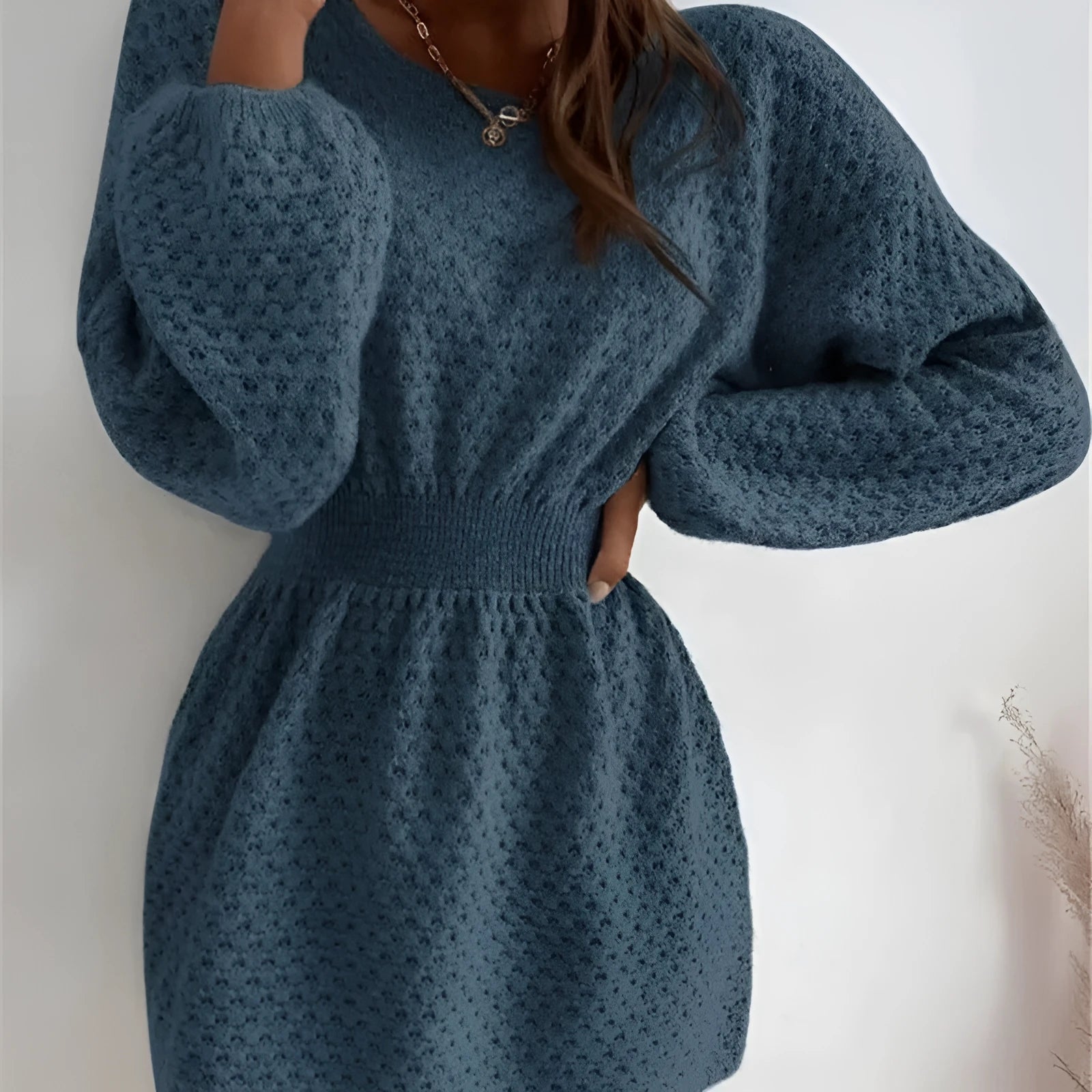 Blue women's knitted dress with hand-crocheted flower decorations and fitted waist