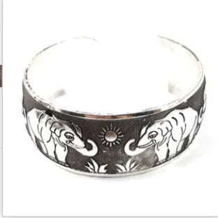 Silver Miao ethnic carved openwork Roman bracelet with elephant motif on alloy material