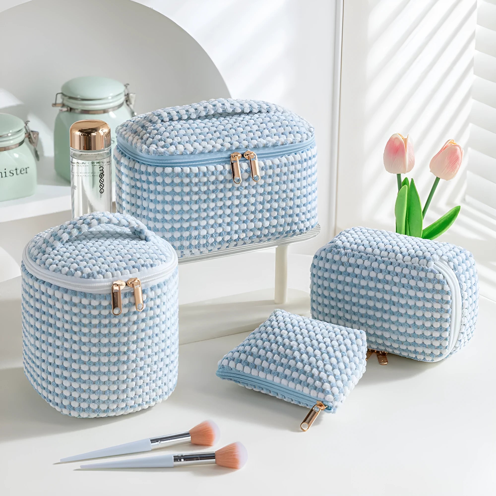 Four cube-shaped polyester makeup bags in matching colour set for travel organisation