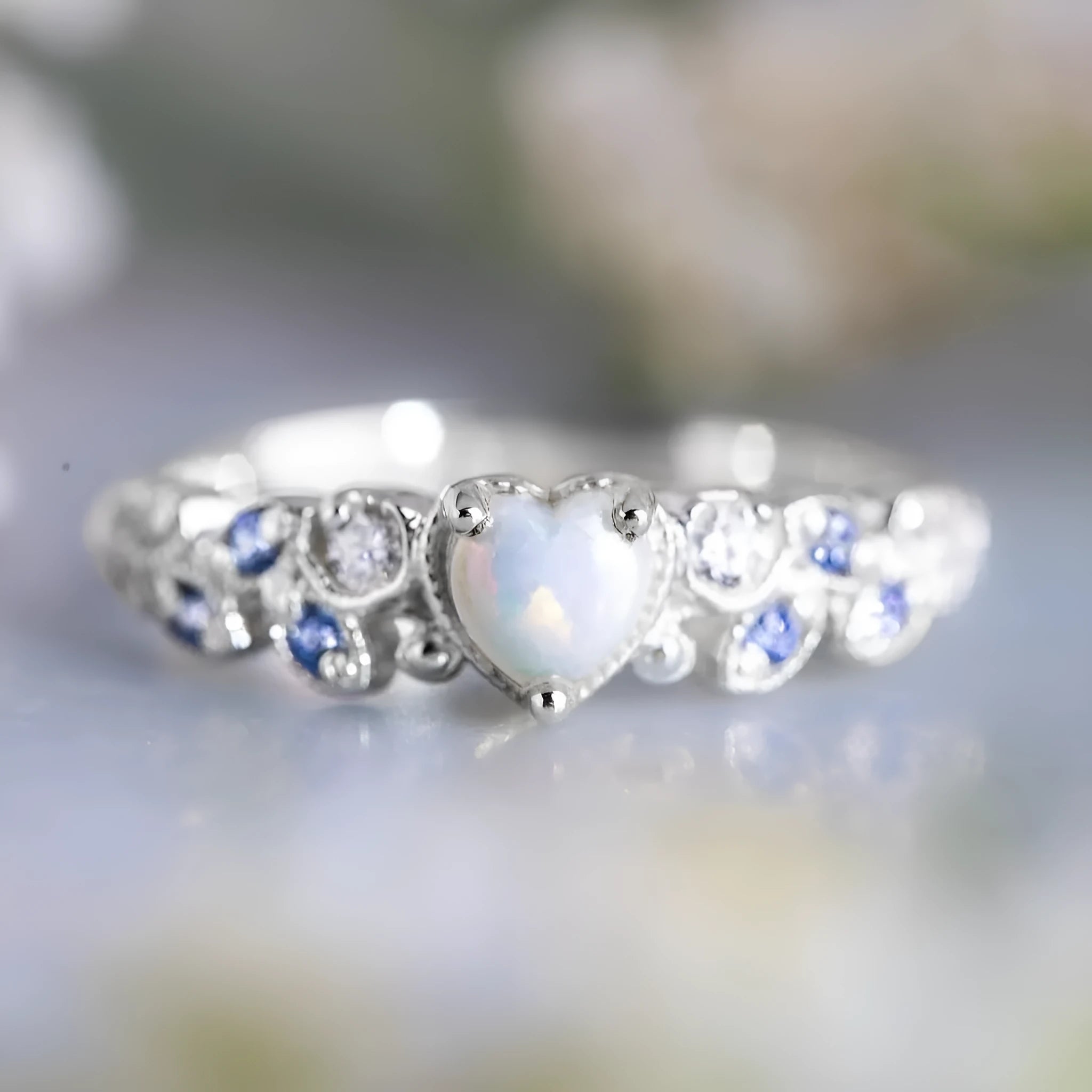 White electroplated alloy women's ring in a heart shape with a flower opal ocean design on its face.