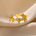 Golden diamond geometric titanium steel women's ring on a hand.