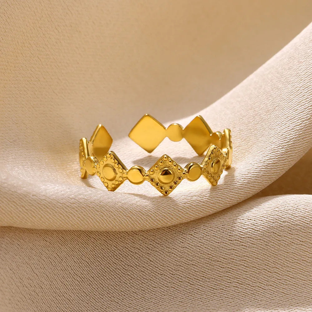 Golden diamond geometric titanium steel women's ring on a hand.