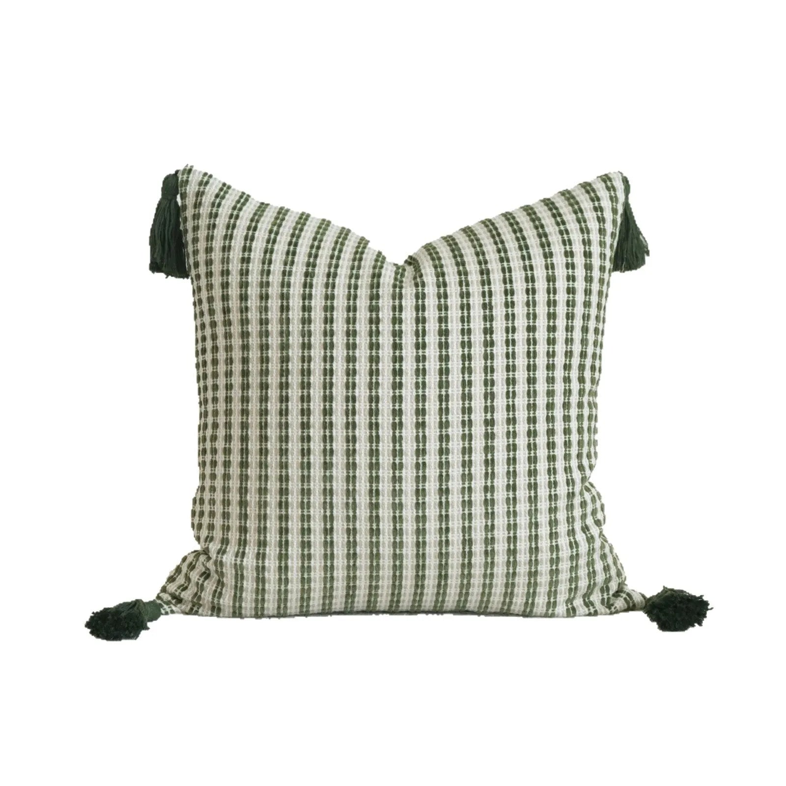 Green striped and botanical patterned hotel sample pillow with tassels on a bed display.