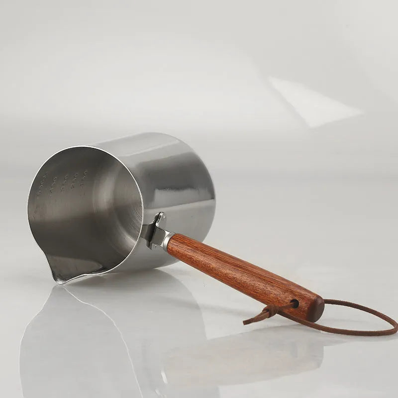 Stainless steel coffee cup with wooden handle and interior measuring scale