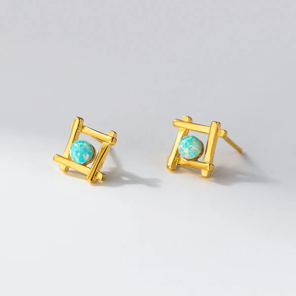 Women's silver geometric cross quadrangle stud earrings with a choice of gold or silver plating.
