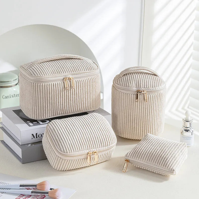 Four cube-shaped polyester makeup bags in matching colour set for travel organisation