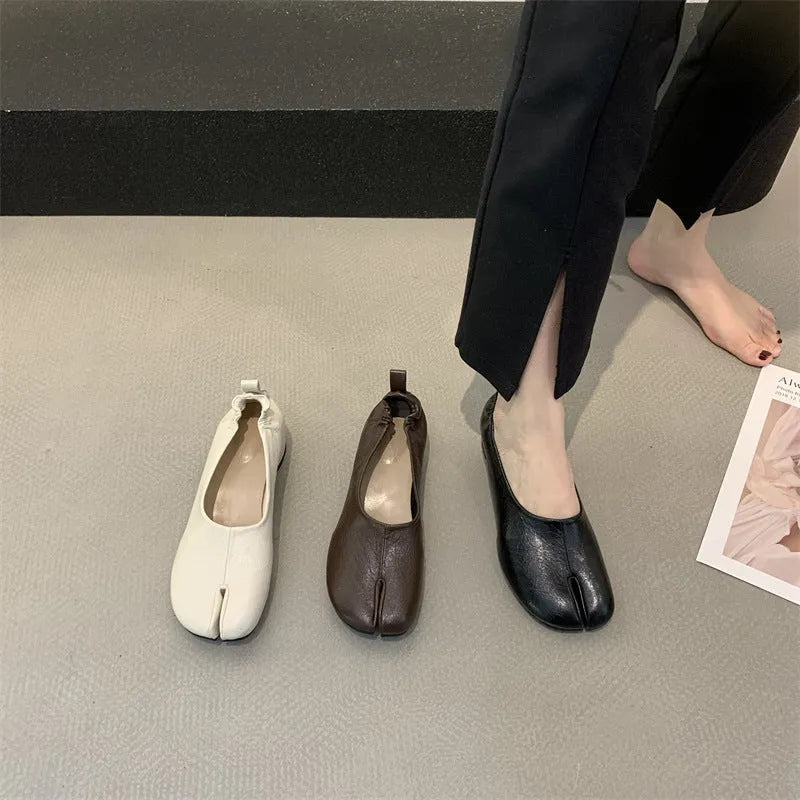 Women's apricot coloured chunky low heel pumps with round toe and split toe horseshoe design detail.