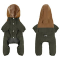 A small dog wearing a khaki coloured British style waterproof polyester shell jacket outdoors.