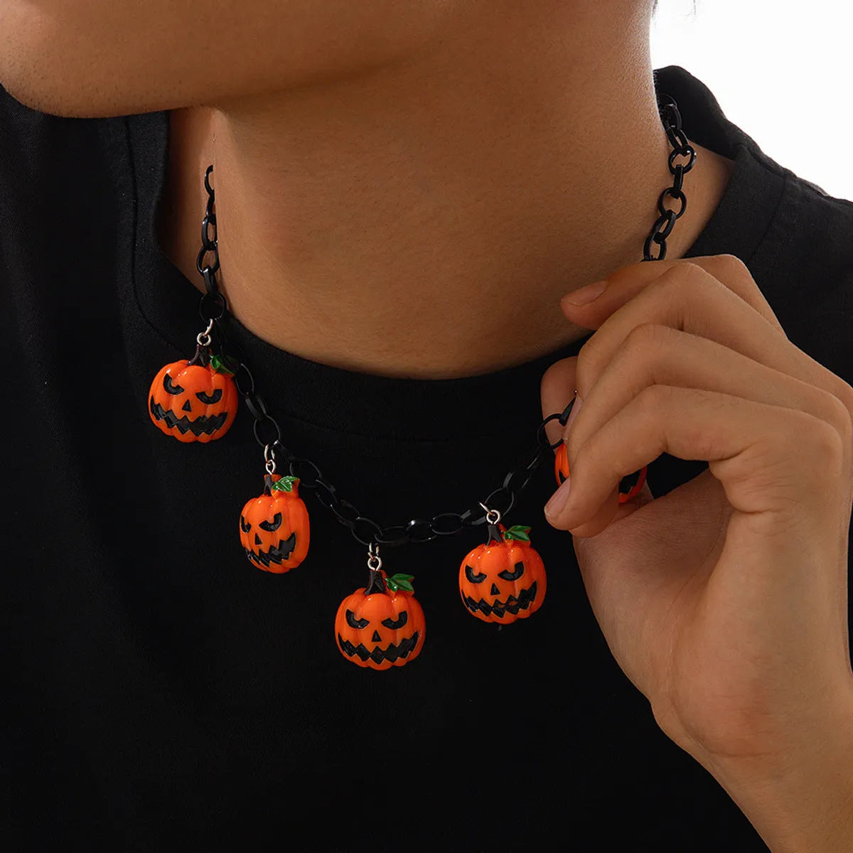 Mixed colour ghost pumpkin acrylic necklace on a regular chain, cartoon Halloween styling.