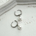 Alloy pearl earrings with geometric round drop design and titanium steel construction