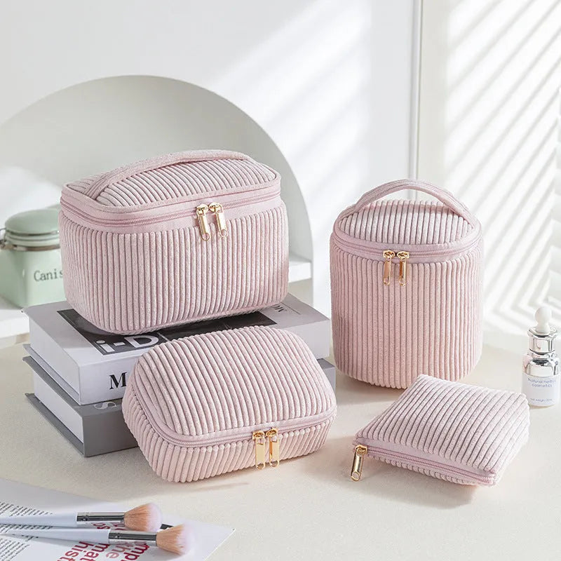 Four cube-shaped polyester makeup bags in matching colour set for travel organisation