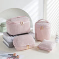 Four cube-shaped polyester makeup bags in matching colour set for travel organisation