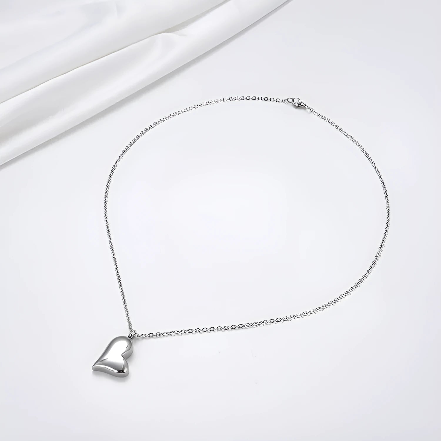 Silver curved peach heart stainless steel pendant necklace on adjustable chain