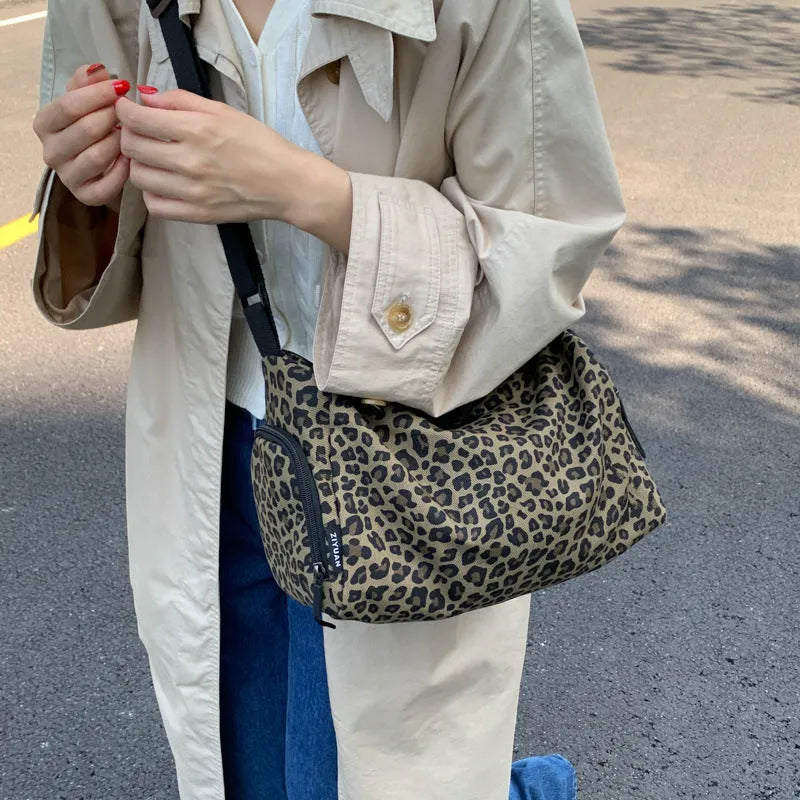 Leopard print sports style shoulder messenger bag with striped lining and stitching details