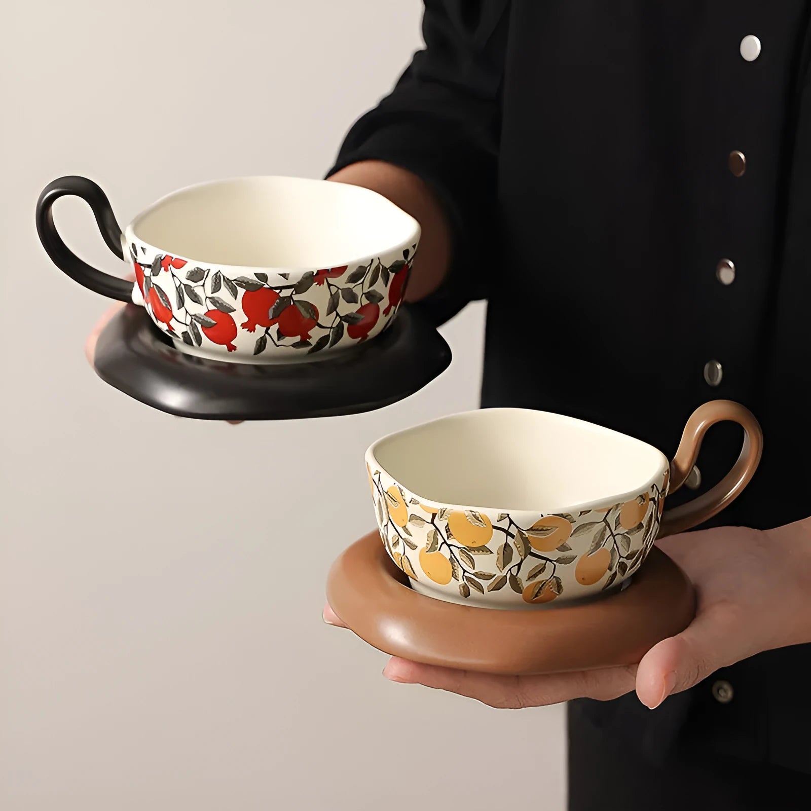 Antique style ceramic coffee cup and saucer with 210ml capacity in black pomegranate or orange citrus pattern.