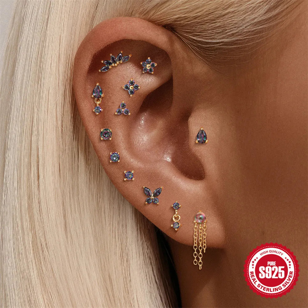 S925 sterling silver thread piercing earring with a flat head rainbow stone in a gold tone.