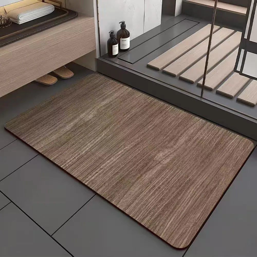 Square diatomite bathroom mat with wood grain pattern on a bathroom floor.